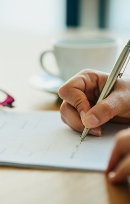 sustainability reporting paper and hand