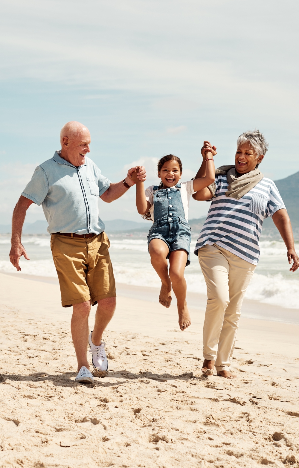Happy family 3 generations on a beach