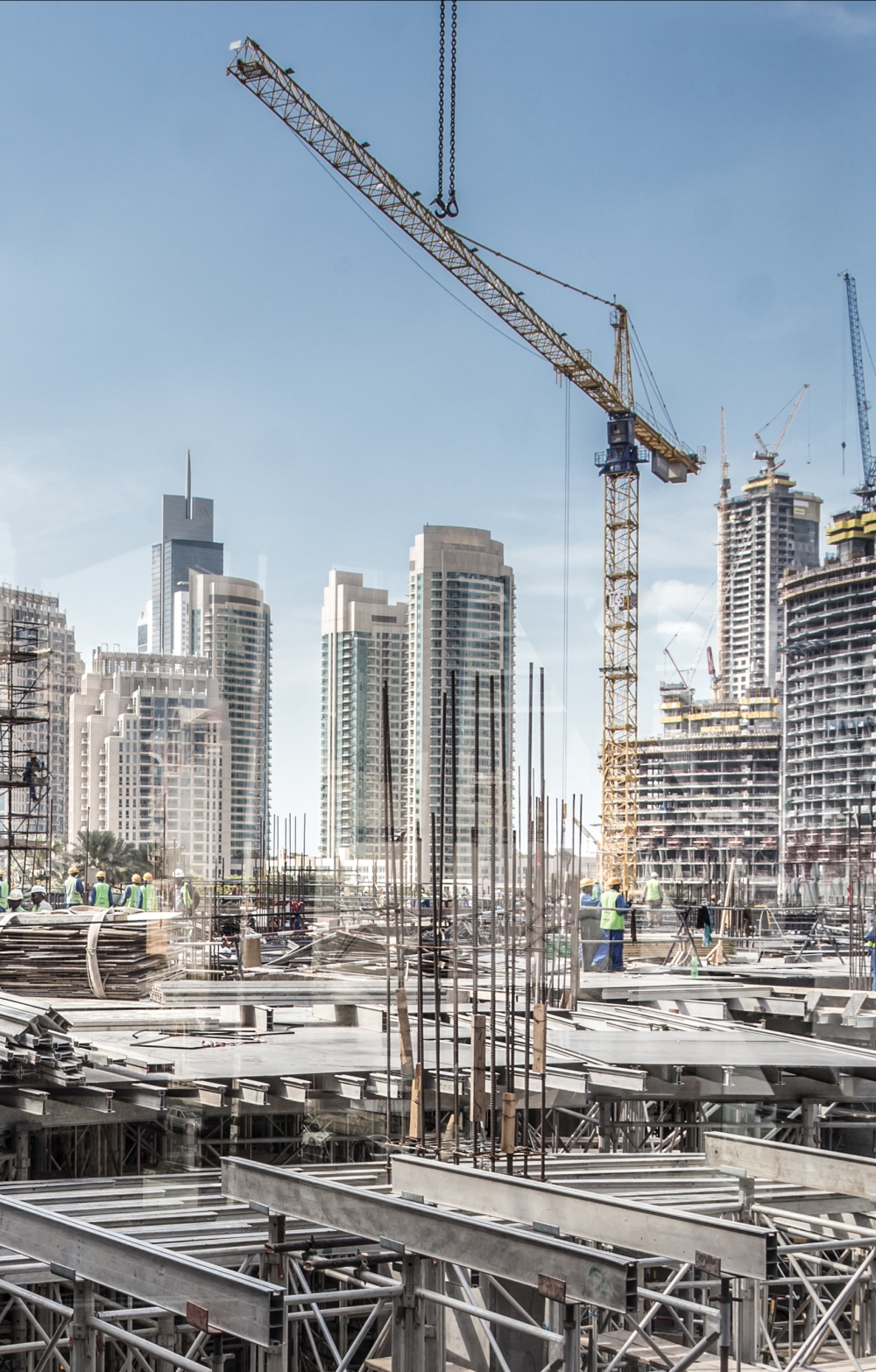Laborers working on modern constraction site works. Fast urban development concept stock photo