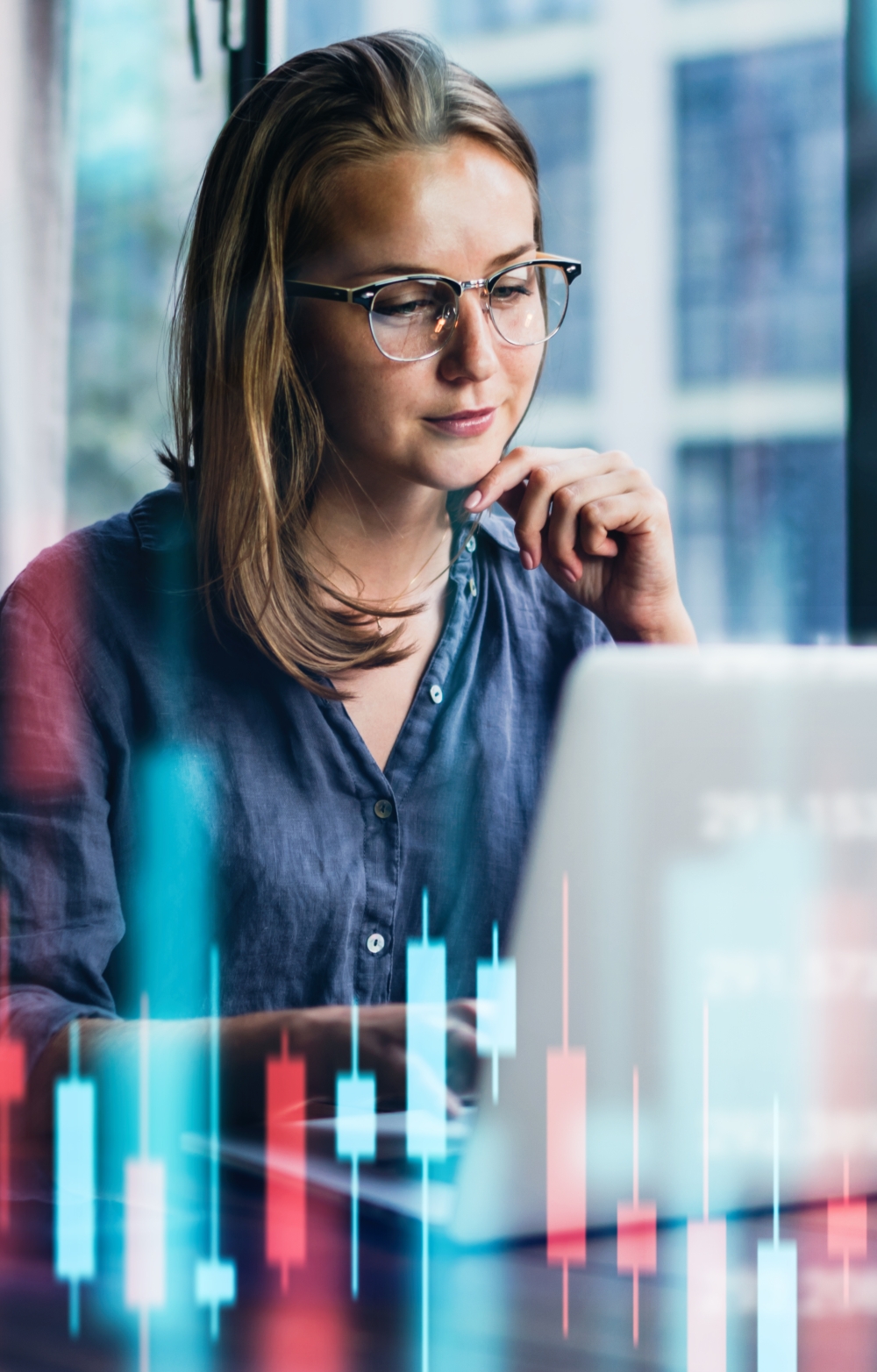 lady looking pensively at a laptop screen agains a virtual background