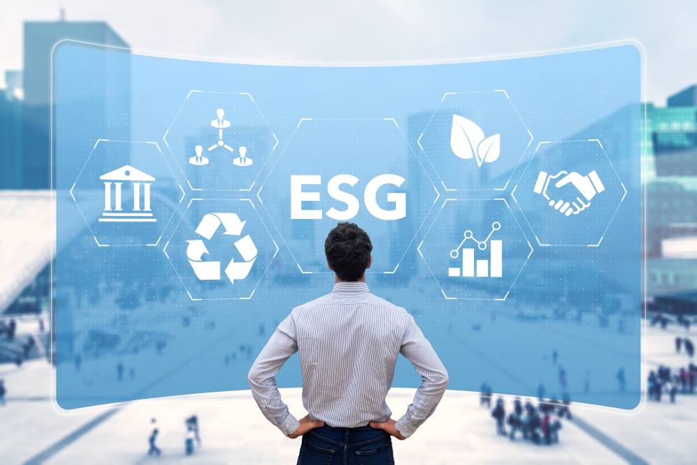 A man looking at a blue wall of ESG symbols