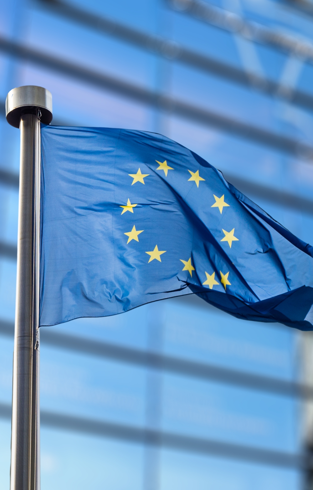 EU Commission building with EU flag flying full mast