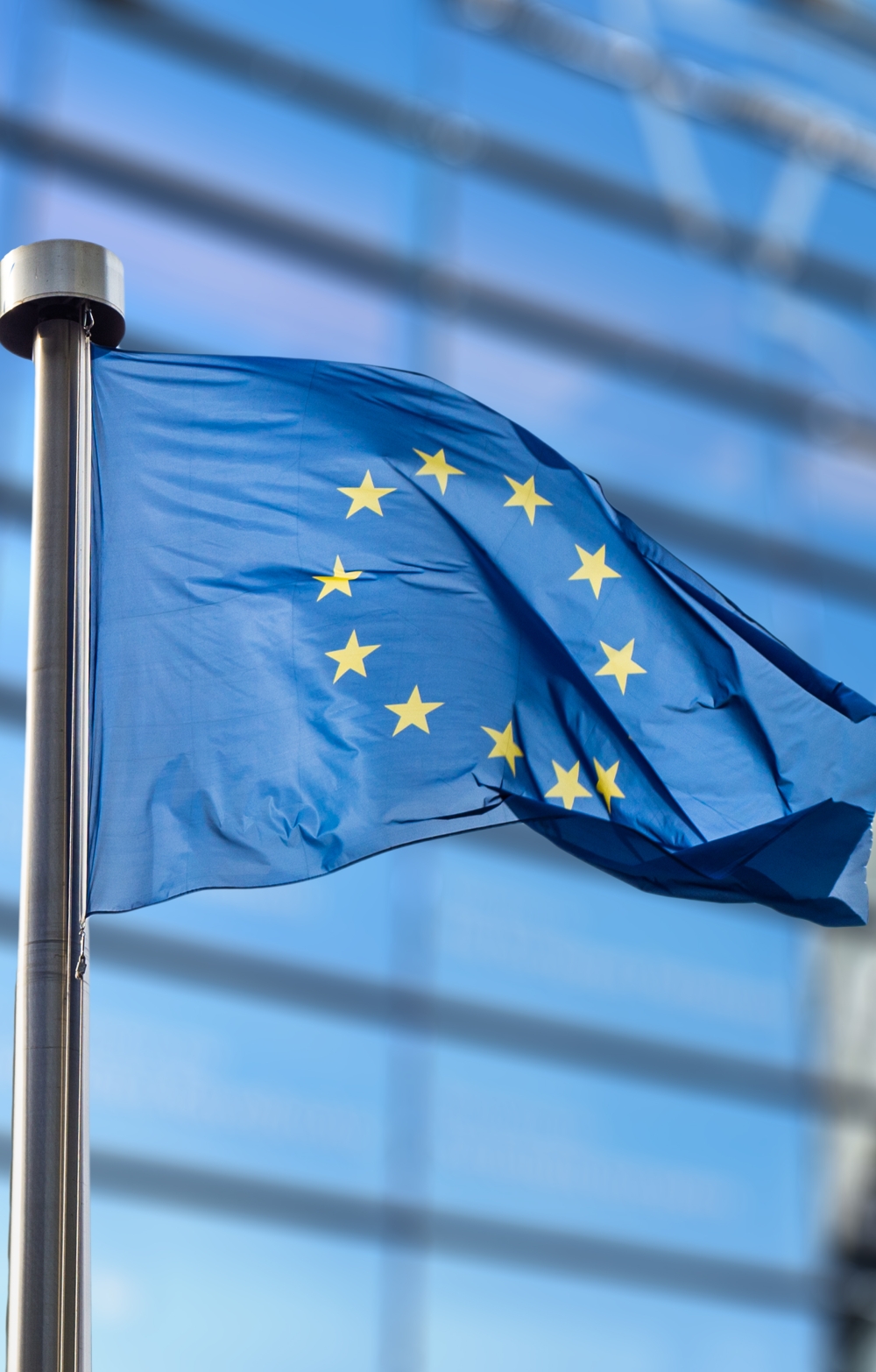EU Flag flying full mast with the EC building in the background