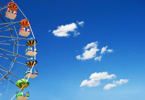 Ferris wheel against a blue sky