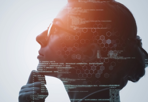 Lady with glasses and hand on chin looking ahead pensively