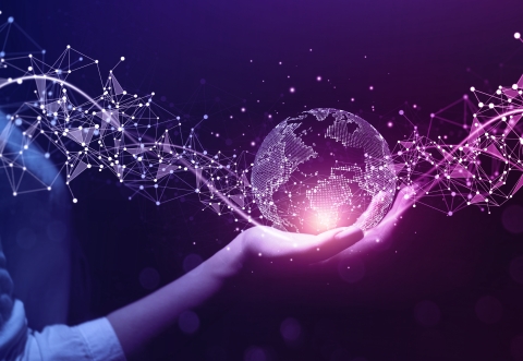 hand of a woman holding an illumanated globe very Dr Who style against a dark background